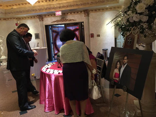 Guests register as they come in. A beautiful portrait of our lovely couple greet them as they enter the ballroom.